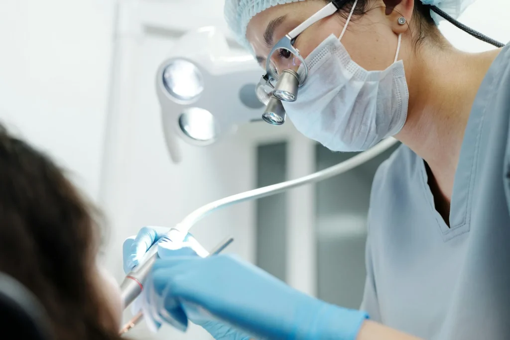 Dental professional performing precision work in a healthcare setting for dental handpiece repair illustration