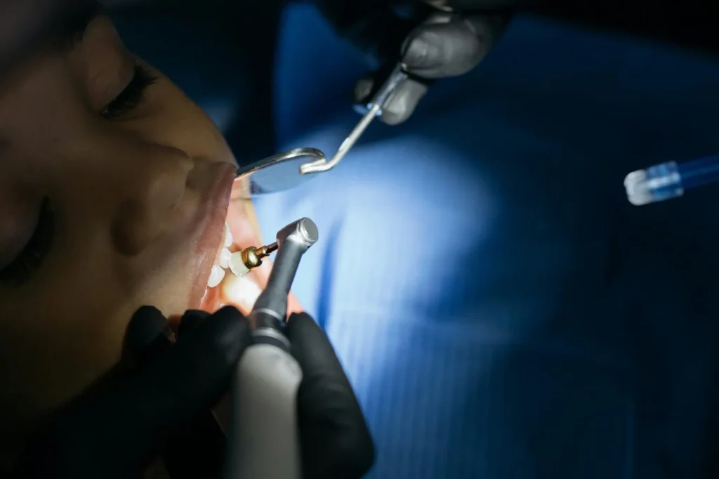 Dental professional working in clinic environment representing dental handpiece repair and servicing